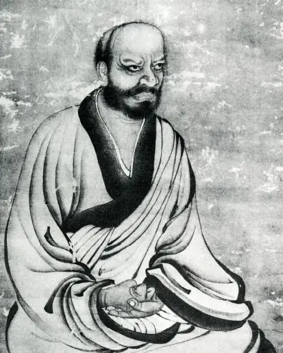 An ink portrait of a scowling seated monk with folded arms.