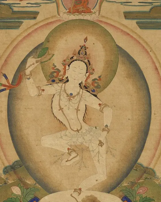 A painting of a white dancing woman holding a drum, within an aureole of light.