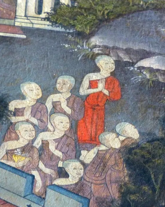A mural detail of shaven-headed nuns in brown robes, one in red, gathered before a stupa.