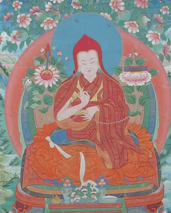 A Tibetan painting of a seated teacher in a red pointed hat, among flowers and smaller figures.