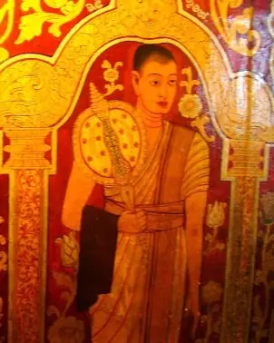 A painting of a monk in an orange robe holding a fan, on a red ground.