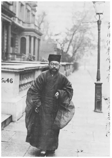 A black-and-white photograph of a man in a dark robe standing on a London street.