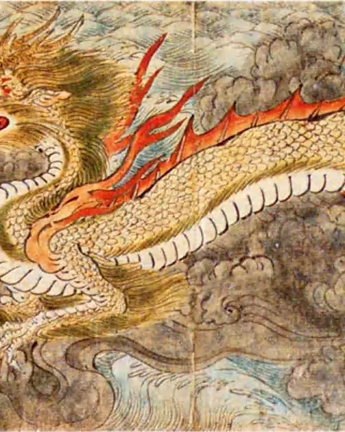 A painted golden dragon with red flames swimming through grey waves.